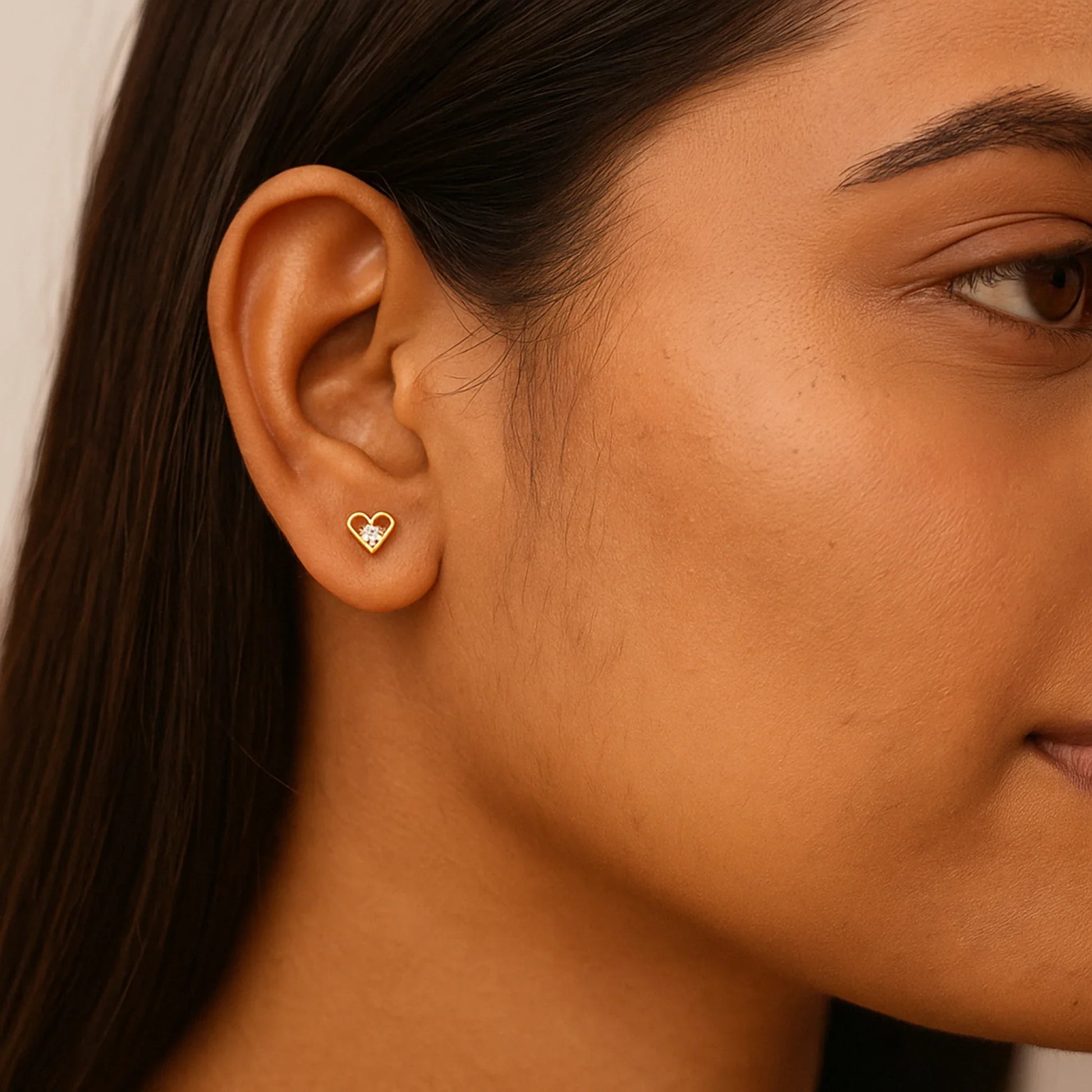 Close-up of a woman wearing 7C Jewel forever yours heart earring