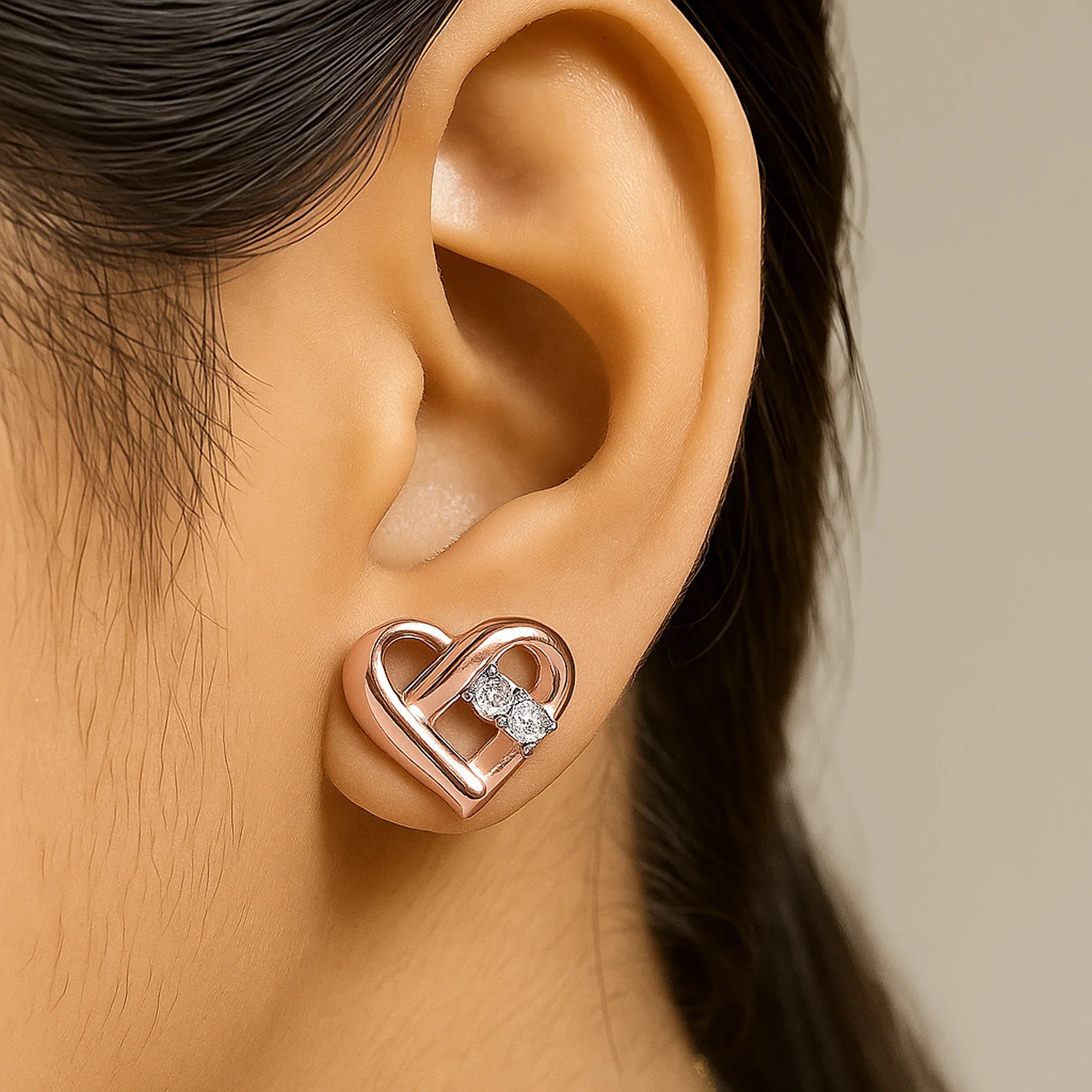 silver sweetheart stud earring with a diamond on model ear
